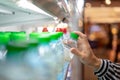 Woman hand chooses drinking water bottle in the supermarket, food and drink, Shopping