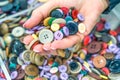 Woman hand choosing colorful buttons from a shelf Royalty Free Stock Photo