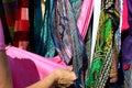 Woman hand choosing colorul scarfs at indian market on India Days in Moscow