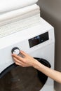 Woman` hand choosing mode in washing machine