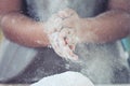Woman hand clapping and sprinkling white flour on dough Royalty Free Stock Photo