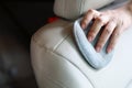 Woman hand cleaning leather seat in car Royalty Free Stock Photo