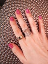 Woman hand coral pink manicure gel nail polish swatch beauty fashion silver decoration texture photo