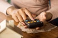 Woman hand counting money background planing to buy or rent home with calculator, blur house model on wooden table Royalty Free Stock Photo