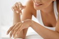 Woman Hand Cream. Close Up Of Beautiful Girl Applying Lotion Royalty Free Stock Photo