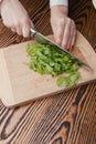 Woman hand cutting spinach using a sharped big kitchen knife Royalty Free Stock Photo