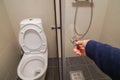 Woman hand with dark blue sweater open the glass shower cabin closet in bathroom Royalty Free Stock Photo