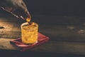 Woman hand decorate orange twist alcoholic cocktail negroni on old wooden board. Drink with gin, campari martini rosso and orange Royalty Free Stock Photo