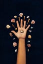 Woman hand and different sea shells on black background conceptual design photo