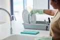 Woman, hand and dishes in kitchen by sink for washing, packing or hygiene in house with gloves. Cleaner lady, hands or