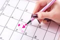 Woman hand drawing and paint heart in calendar with felt pen for Valentines day Royalty Free Stock Photo