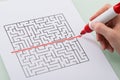 Woman Hand Drawing Straight Red Line Over Maze Royalty Free Stock Photo