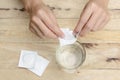 Woman hand dropping effervescent tablet in a glass of water Royalty Free Stock Photo