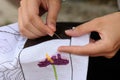 Woman hand embroiders