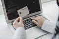 Woman hand entering password code on laptop computer paying bill with credit card on desk at home office, internet, digital market Royalty Free Stock Photo