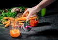 Woman hand filling bottle with fresh carrot juice Royalty Free Stock Photo