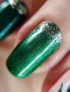 Woman hand finger green silver glitter shimmer manicure gel nail polish swatch design beauty fashion macro photo Royalty Free Stock Photo