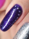 Woman hand finger violet purple silver metallic glitter manicure gel nail polish swatch design beauty macro photo Royalty Free Stock Photo