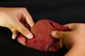 Woman hand folding banana blossom.