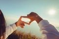 woman hand framing looking view sunrise