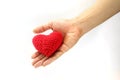 Woman hand give red crocheted heart. Valentine`s Day. Symbol of love. Royalty Free Stock Photo
