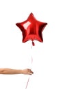 Woman hand give single big red star latex balloon for birthday party isolated on a white Royalty Free Stock Photo