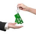 Woman hand giving key with green grass house keyring Royalty Free Stock Photo