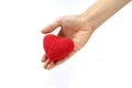 Woman hand giving red crocheted heart. Valentine`s Day. Symbol of love. Royalty Free Stock Photo