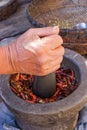 Woman hand is grinding chili and garlic by Granite mortar and pe Royalty Free Stock Photo