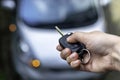 Woman hand hand holding contactless car key and pressing the button on the remote to lock or unlock the car Royalty Free Stock Photo