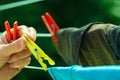 Woman hand hanging wet clothes on rope line Royalty Free Stock Photo