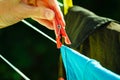Woman hand hanging wet clothes on rope line Royalty Free Stock Photo