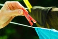 Woman hand hanging wet clothes on rope line Royalty Free Stock Photo