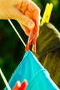 Woman hand hanging wet clothes on rope line Royalty Free Stock Photo