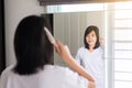 Woman hand having combing her hair in bedroom mirror Royalty Free Stock Photo