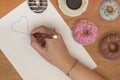Woman hand, heart and donuts Royalty Free Stock Photo