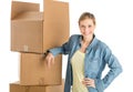 Woman With Hand On Hip Leaning On Stacked Cardboard Boxes Royalty Free Stock Photo