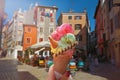 Woman hand hold  beautiful bright  sweet ice - cream cone with different flavors   held in hand Royalty Free Stock Photo