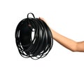 Woman hand hold bunch black electrical wire roll isolated on a white Royalty Free Stock Photo