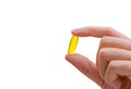 Woman hand hold fish oil capsule. Woman taking omega-3 pills. Vitamins and supplements concept.