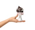 Woman hand hold and give little meringues or souffle chocolate cake