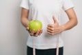 woman hand hold green Apple, happy female fitness choose fruit is Healthy food. Dieting control, Weight loss, Obesity, eating Royalty Free Stock Photo