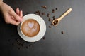 Woman hand hold the latte art coffee flat lay . fresh morning lifestyle