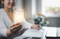 Woman hand hold light bulb with icons work on the desk, Creativity and innovation are keys success. Concept of new idea and innova Royalty Free Stock Photo