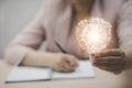 Woman hand-hold light bulb with icons work on the desk, Creativity and innovation are keys to success. Concept of new idea and inn Royalty Free Stock Photo