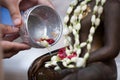 Woman hand hold little bowl to bath Buddha statue Royalty Free Stock Photo