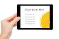 Woman hand hold a mini tablet with orange Royalty Free Stock Photo