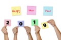 Woman hand hold Paper notes with label Happy New Year 2019 New Royalty Free Stock Photo