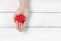 Woman Hand Hold Paper Red Heart on white wood background. Protect Love or Health Concept with Copy Space Royalty Free Stock Photo