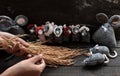 Woman hand hold sheaf of paddy, feeding group cute grey mice